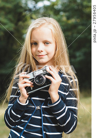 Cute little girl with a vintage camera. 27956405