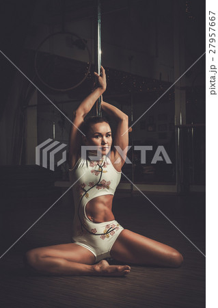 Beautiful woman performing pole dance on pole 27957667