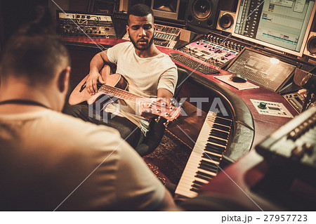 Two professional guitarists performing in boutique 27957723