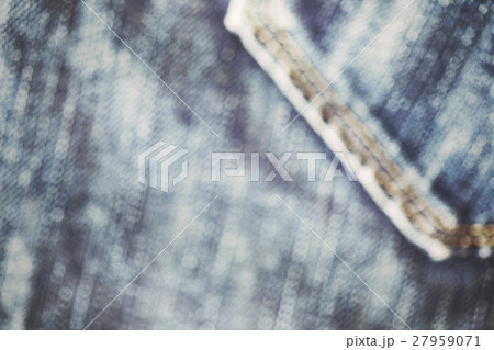 Blurred close up picture of blue jeans fabric. 27959071