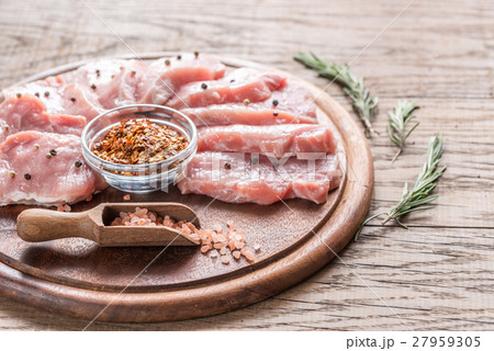 Raw pork steaks on the wooden board Raw pork steaks on the wooden board 27959305