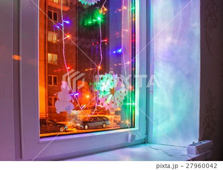 bright colored electric garland in the window 27960042
