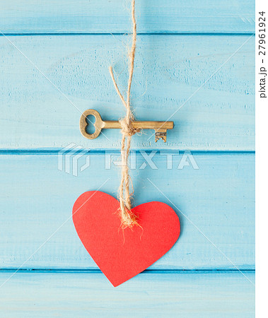Skeleton key and heart hanging over turquoise wood 27961924
