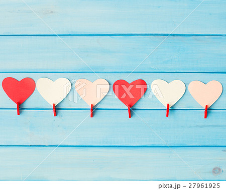 Hearts and red clothespins over turquoise wood 27961925