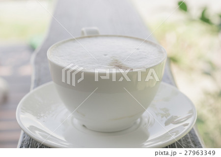 Cup of coffee on wooden table in cafe. Cup of coffee on wooden table in cafe. 27963349
