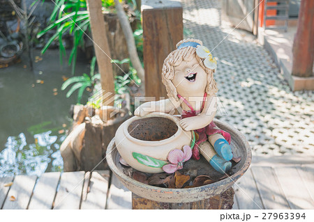 Statue of a girl sitting next to a vase Statue of a girl sitting next to a vase 27963394