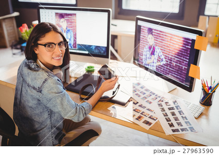 Graphic designer holding digital camera Graphic designer holding digital camera 27963590