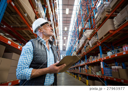 Worker looking up in warehouse Worker looking up in warehouse 27963977