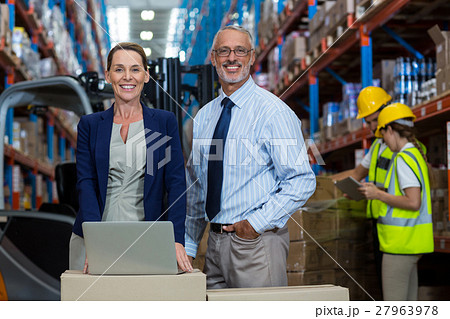 Portrait of happy managers are posing and looking the camera during work Portrait of happy managers are posing and looking the camera during work 27963978