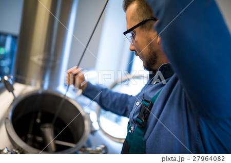 Brewer working at brewery Brewer working at brewery 27964082