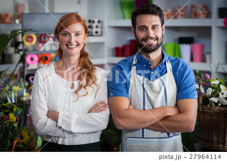 Couple standing with arms crossed Couple standing with arms crossed 27964114