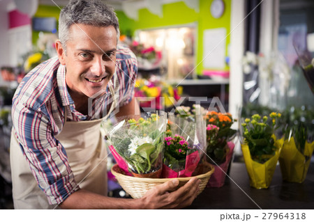Male florist arranging bouquet of flower Male florist arranging bouquet of flower 27964318
