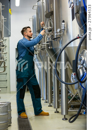 Maintained worker working at brewery Maintained worker working at brewery 27964533
