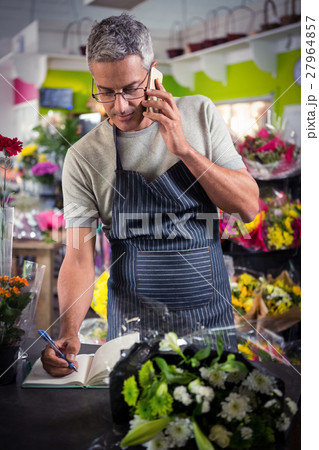 Male florist taking order on mobile phone 27964857