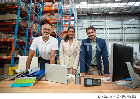 Low angle view of worker team is posing and smiling during work Low angle view of worker team is posing and smiling during work 27964882