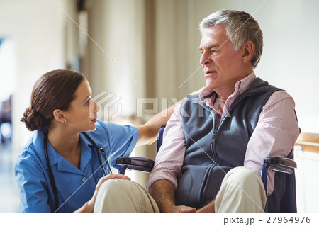 Nurse taking care of sad senior man Nurse taking care of sad senior man 27964976