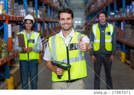Worker with thumb up wearing yellow safety vest Worker with thumb up wearing yellow safety vest 27965071