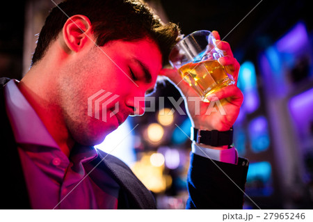 Depressed man having whisky at bar counter Depressed man having whisky at bar counter 27965246