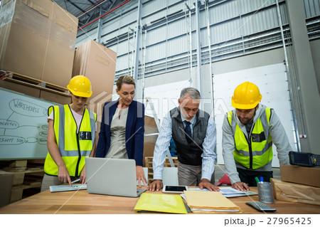 Warehouse team working on laptop and digital tablet Warehouse team working on laptop and digital tablet 27965425