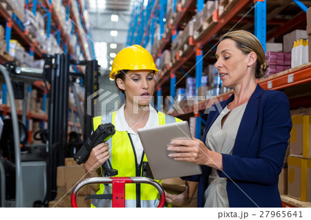 Businesswoman and warehouse worker Businesswoman and warehouse worker 27965641