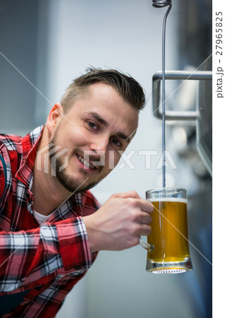 Close-up of brewer testing beer Close-up of brewer testing beer 27965825