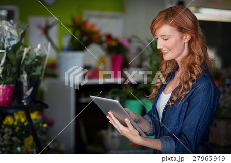 Female florist using digital tablet 27965949