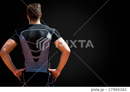 Rear view of sportsman posing with hands on hips 27966382