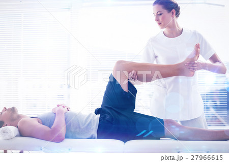 Composite image of physiotherapist massaging leg of man 27966615