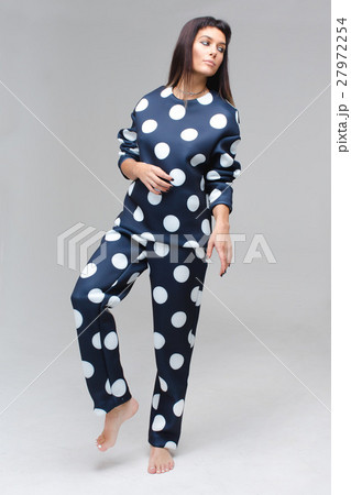 Barefoot model in blue polka dots pajamas staying Barefoot model in blue polka dots pajamas staying 27972254