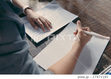 Asian girl reading and make a note of something in 27973185