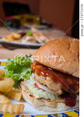 Close up of hamburger and fries. Close up of hamburger and fries. 27973336