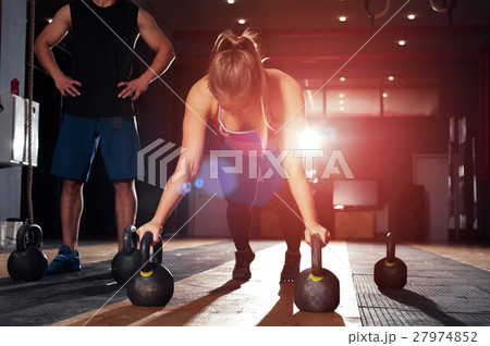 Cute blonde girl doing push ups in gym Cute blonde girl doing push ups in gym 27974852