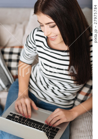 Pleased elegant lady writing an email 27975784