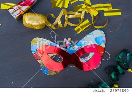 Masquerade decorations on dark wooden background Masquerade decorations on dark wooden background 27975840