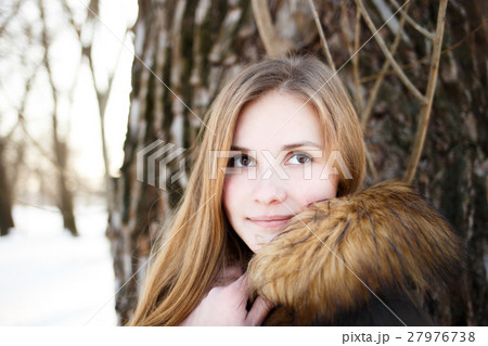 Portrait of Young smiling girl in winter park 27976738