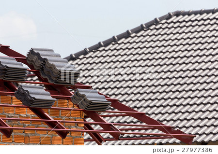 black tile roof on residential building 27977386