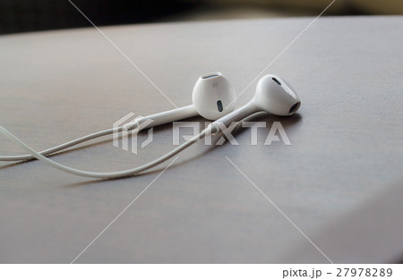 earphones on pastel wooden texture, soft focus earphones on pastel wooden texture, soft focus 27978289