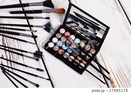 Set of natural brushes and eye shadow palette. Set of natural brushes and eye shadow palette. 27985178