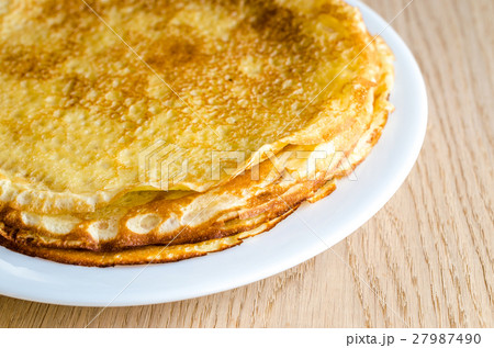 Pile of crepes on the wooden background Pile of crepes on the wooden background 27987490