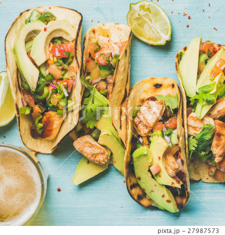 Healthy corn tortillas and beer over blue Healthy corn tortillas and beer over blue 27987573