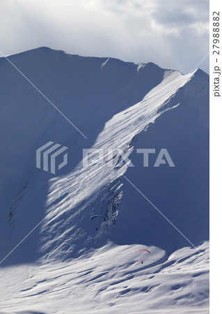 Speed riding in snow mountains at sun evening Speed riding in snow mountains at sun evening 27988882