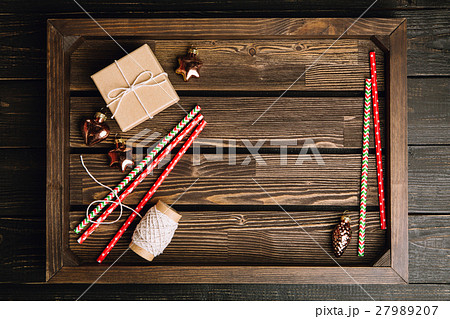 Brown wooden tray with Christmas decorations Brown wooden tray with Christmas decorations 27989207