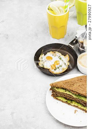 Breakfast - a toast from rye bread with avocado 27990927