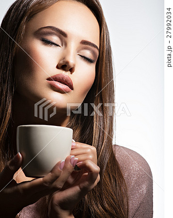 Woman with cup of coffee Woman with cup of coffee 27992034