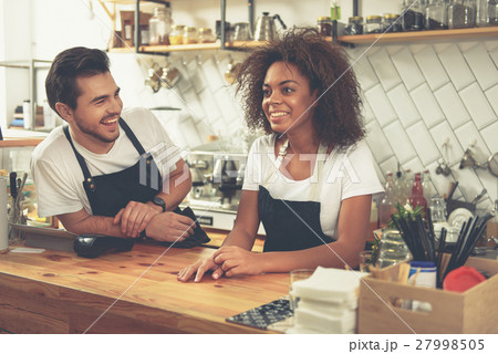 Outgoing baristas speaking during their work in 27998505