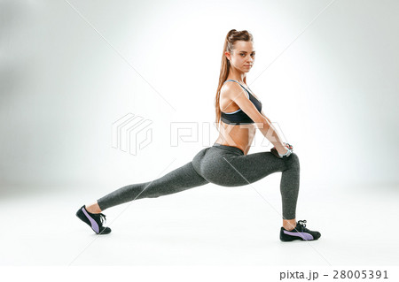 Beautiful slim brunette doing some stretching 28005391