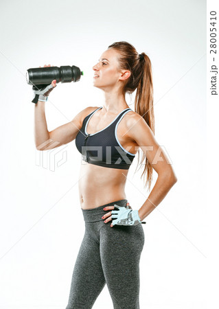 Muscular young woman athlete with a water on black Muscular young woman athlete with a water on black 28005410
