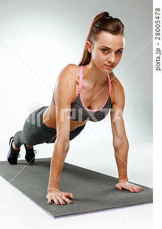 Beautiful slim brunette doing some stretching 28005478