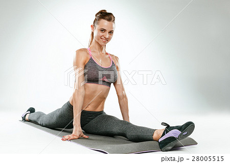 Beautiful slim brunette doing some stretching 28005515