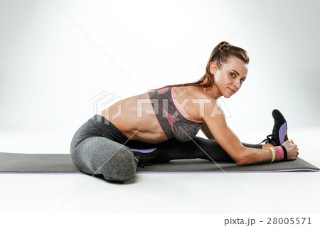 Beautiful slim brunette doing some stretching 28005571